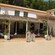 A low slung stucco restaurant with an outdoor patio